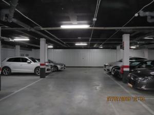 a parking garage with several cars parked in it at Apartamentos Cachón in Zahara de los Atunes