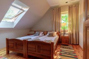 a bedroom with a bed and a skylight at Dom Na Wsi in Zachełmna