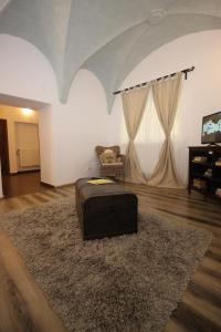 a living room with a suitcase sitting on a rug at Gothic Apartment in Braşov