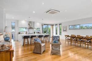 a large kitchen and living room with wooden floors at Coastal Beach House Luxury with Ocean Views in Aireys Inlet