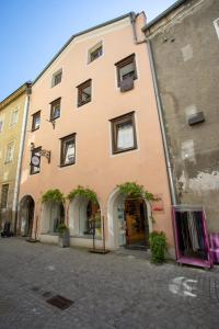 a large orange building on a street at Old Town Studio in Hall in Tirol