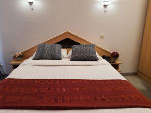 Postel nebo postele na pokoji v ubytování Hotel New Flanders
