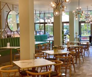a row of tables and chairs in a restaurant at Apart. Albus in Świnoujście