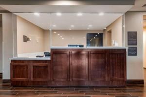 a lobby with a reception desk in a building at Comfort Suites Daytona Beach-Speedway in Daytona Beach