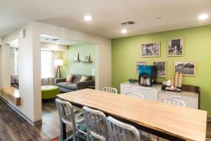a kitchen and living room with a table and chairs at WoodSpring Suites Lake Jackson in Lake Jackson