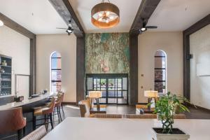 a dining room with a fireplace and a large painting on the wall at Clarion Inn Page - Lake Powell in Page