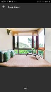 
a living room with a couch and a window at Ganga Kutir in Raichak
