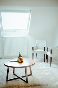 a living room with a table and chairs at Heirloom Hotels - A Flemish Tale in Ghent