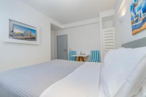 Voodi või voodid majutusasutuse Central Fira Suites toas