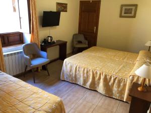 Postel nebo postele na pokoji v ubytování Hostal Loreto