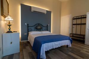 1 dormitorio con 1 cama con pared azul en B&b IL CERE, en Alseno