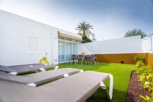 un patio con mesa y sillas en el césped en New 3BR with great terrace By CanariasGetaway, en San Bartolomé