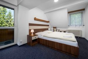 Postel nebo postele na pokoji v ubytování Horský Hotel Jelínek + 30 fotografií