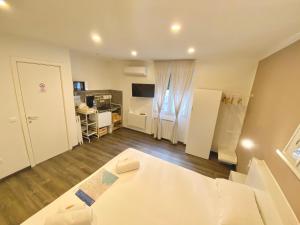 ein Wohnzimmer mit einem Bett und eine Küche in der Unterkunft Mimì Rooms&Studios in Triest