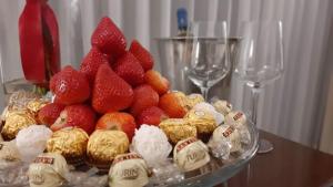 a plate of strawberries and chocolates on a table at Hotel Lopez Campeche in Campeche