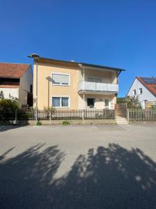 a house with a fence in front of a street at Pension Miranda in Kelheim