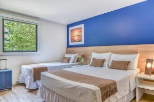 Postel nebo postele na pokoji v ubytování Cais da Praia Hotel