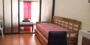 a bedroom with a bed with a teddy bear sitting on it at Joi's One Oasis Condo Near Limketkai Mall in Cagayan de Oro