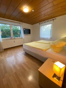 a bedroom with a bed and a table with a lamp at Pension Miranda in Kelheim