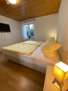 a bedroom with a large bed with a window at Pension Miranda in Kelheim