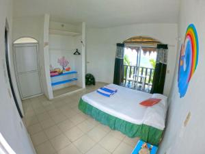 a bedroom with a bed and a window with a view at Casa Kayab in Puerto Morelos
