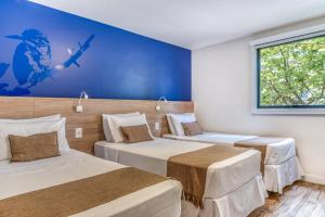 Postel nebo postele na pokoji v ubytování Cais da Praia Hotel