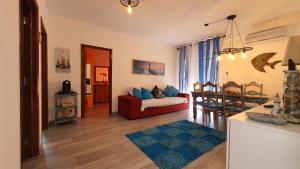 a living room with a red couch and a table at Monte Gordo T2 Frente Mar in Monte Gordo