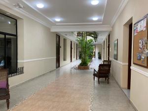 an empty hallway with chairs in a building at Hotel Lopez Campeche in Campeche