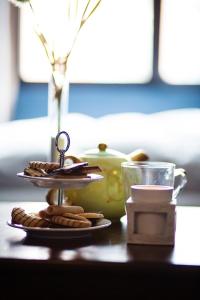 una mesa con un plato de galletas y una taza en Apartement 24, Hotell, en Estocolmo