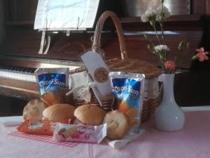 a basket of food sitting on a table next to a piano at Schofield Guest House in Bridlington