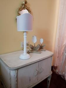 a white table with a lamp on top of it at La Bouganville e Il Gelsomino in Pietrasanta +80 photos