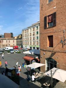 a group of people walking around in a parking lot at Triquetra - Rooms for Rent in Ferrara