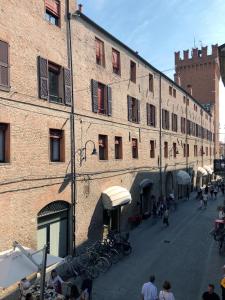 a large brick building with bikes parked outside of it at Triquetra - Rooms for Rent in Ferrara
