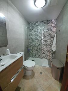 a bathroom with a toilet and a sink and a shower at Mi Cotillo in Cotillo +11 photos
