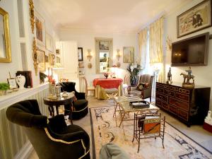 a living room filled with furniture and a tv at Alma-Eiffel Tower in Paris