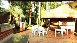 a group of chairs and a table and a gazebo at Riviera São Lourenço Acqua in Bertioga