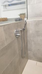 a shower in a bathroom with a shower head at Apartment Airport Cologne in Cologne +13 photos