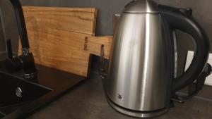 a tea kettle sitting on a counter next to a sink at Apartment Airport Cologne in Cologne