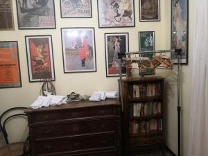 a room with a dresser and posters on the wall at POGGIO ECO B&B in Ascoli Piceno