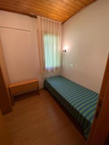 A bed or beds in a room at Residence Tarvisio Camporosso