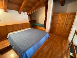 A bed or beds in a room at Residence Tarvisio Camporosso