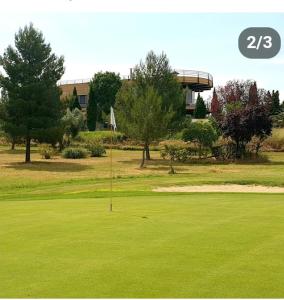 a putting green with a flag in the middle of it at Toledo ciudad de las tres culturas , un lugar para disfrutar todas las familias con sus hijos " DESAYUNO INCLUIDO" in Villamiel de Toledo