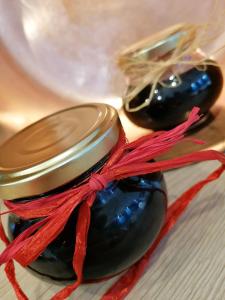 a close up of two black olives with a red bow at Maison La Vigne - Gîtes et Chambres d'hôtes in Le Chambon-sur-Lignon