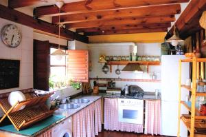 a kitchen with a sink and a stove top oven at Casasdetrevijano Cañon del rio leza in Soto en Cameros