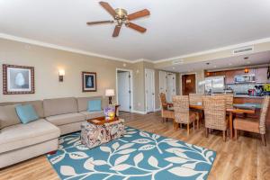 a living room with a couch and a dining room at Maui Westside - Honua kai Konea 642/643 in Kaanapali