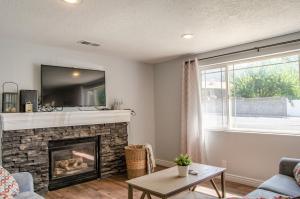 a living room with a fireplace and a tv at Never Stop Exploring- 3 bedroom 2 bath home of duplex, close to Zion, Bryce, and Brianhead in Cedar City