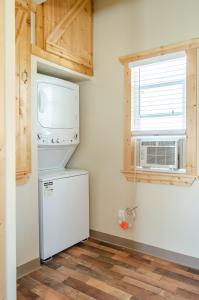 a kitchen with a white refrigerator and a window at Cedar Wood Escape in Cedar City