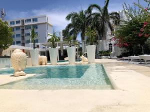a swimming pool with statues of animals in a building at Le Castel Blanc Hotel Boutique in San Andrés