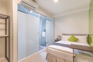 台北的住宿－T.O. Hotel 台北車站，一间卧室设有一张床和一个滑动玻璃门