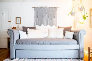 a blue couch with pillows on it in a room at Craftsbury Farmhouse in Craftsbury